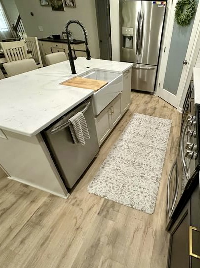 White kitchen with stainless fridge